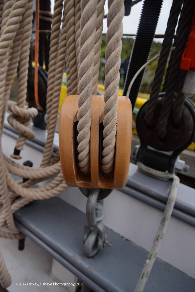 A block used to control and direct lines on a ship when hoisting a sail.